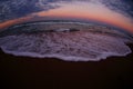 Fisheye view of sea waves at sunset Royalty Free Stock Photo