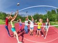 Fisheye view of teenagers playing volleyball Royalty Free Stock Photo