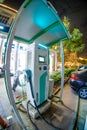 fisheye wideangle shot of exicom fast car charger with a pay and charge concept showing the growth of electric vehicles