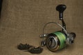 Fishing, carp reel with fishing linel on the background of burlap . Burlap