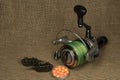 Fishing, carp reel with fishing linel on the background of burlap . Burlap Royalty Free Stock Photo