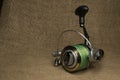 Fishing, carp reel with fishing linel on the background of burlap . Burlap