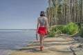 Fishing. Back view of sexy girl with walleye zander fish trophy at lake coast Royalty Free Stock Photo