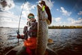 Fisherman and big trophy Pike. Royalty Free Stock Photo