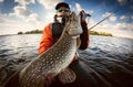 Fisherman and big trophy Pike. Royalty Free Stock Photo