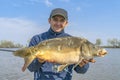 Fishing backgrounds. Fisherman with carp fish in hands