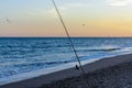 Fishing on the beach at sunset Royalty Free Stock Photo