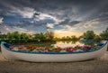 Boat filled with flowers in an iconic beautiful sunset landscape over the Danube Delta in Gura Portitei, Romania