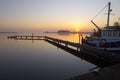 Fishing boat along a jetty Royalty Free Stock Photo