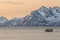 Fishing boat with amazing sunset in background in lofoten, norway