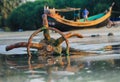 A fishing boat anchored by the beach in St. Martin`s Island, Bangladesh. Fishing boat rusty traditional anchor on a beach.