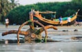 A fishing boat anchored by the beach in St. Martin`s Island, Bangladesh. Fishing boat rusty traditional anchor on a beach.