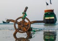 A fishing boat anchored by the beach in St. Martin`s Island, Bangladesh. Fishing boat rusty traditional anchor on a beach.