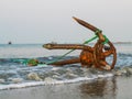 A fishing boat anchored by the beach in St. Martin`s Island, Bangladesh. Fishing boat rusty traditional anchor on a beach.