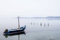 Fishing boat anchored in a sea bay with flat water Royalty Free Stock Photo