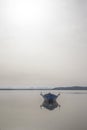 Fishing boat anchored in a sea bay with flat water