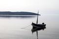 Fishing boat anchored in a sea bay with flat water Royalty Free Stock Photo