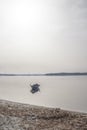 Fishing boat anchored in a sea bay with flat water Royalty Free Stock Photo