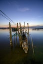Fishing boat anchoring at pier during sunset