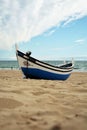 Fishing boat. Atlantic ocean beach. Portugal. Sand water waves and the sky clouds. Blue white. Europe. Travel. Royalty Free Stock Photo