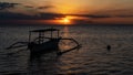 Fishing boat on the background of a beautiful sunset by the ocean on the island of Bali Royalty Free Stock Photo