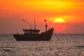 Fishing boat in the background of a huge sunset