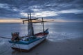 A fishing boat on beach in dawn Royalty Free Stock Photo