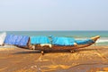 Fishing boat on a black beach. Varkala. India