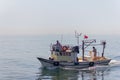 Fishing boat on the Bosporus,surrounded by seagulls in Turkey