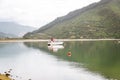 Fishing boat in a calm lake water/old wooden fishing boat/ wooden fishing boat in a still lake water Royalty Free Stock Photo