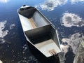 Fishing boat between clouds, sky with clouds in a water surface mirror Royalty Free Stock Photo