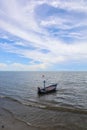 Fishing boat in the cloundy sea