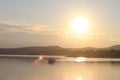 A fishing boat crosses the sea bay in the morning sun. Dawn at the resort. Heavy human labor. Calm and rest after sea crossing. Cr