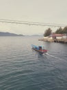 Fishing boat crossing under Ulee Lheue Brigde, Aceh, Indonesia. Royalty Free Stock Photo