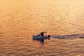 Fishing boat dinghy at sea in sunset Royalty Free Stock Photo