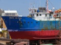 A fishing boat in dire need of repairing in dry dock in Cape Town Royalty Free Stock Photo