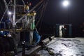 Fishing Boat at Dockside at Night Preparing to go to Sea with Trawler Men and Officials Royalty Free Stock Photo