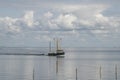 Fishing boat is emptying the nets, placed along the Aflsluitdijk in a calm peacfull IJsslemeer Royalty Free Stock Photo