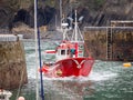 Fishing boat entering a port of a village in the Basque country, Spain Royalty Free Stock Photo