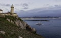 Fishing boat entering during sunset,sailing in front of the lighthouse of Saint Juan, to the port Royalty Free Stock Photo