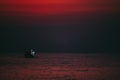 Fishing boat of fisherman go out to sea or ocean at night time before sunrise with dark tone. Royalty Free Stock Photo