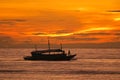 Fishing Boat and Fishermen under a Brilliant Island Sunrise