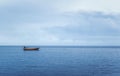 Fishing boat floating alone in the sea Royalty Free Stock Photo