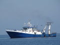 Fishing boat floating on a sea. Royalty Free Stock Photo