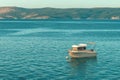 Fishing boat floating on water close to the Adriatic sea shoreline in Kvarner bay Royalty Free Stock Photo