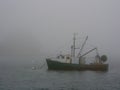 Fishing boat in fog Royalty Free Stock Photo