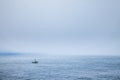 A fishing boat in the fog just off the coast of Cape Flattery, Washington Royalty Free Stock Photo