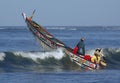 Fishing boat going over a wave