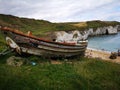 Fishing Boat and Grass Beach Scene at North Landing, Flamborough Head Royalty Free Stock Photo