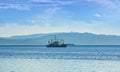 Fishing boat in gray morning on Pacific ocean off the coast of the Kamchatka Peninsula